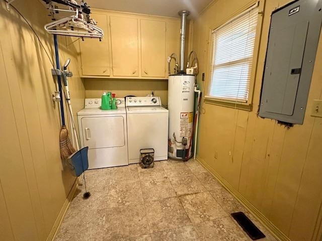 washroom with wood walls, independent washer and dryer, electric panel, cabinets, and gas water heater