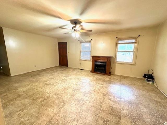 unfurnished living room featuring ceiling fan