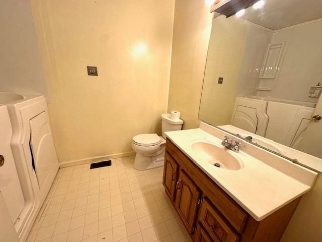 bathroom featuring vanity, toilet, and tile patterned flooring