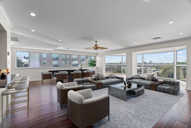 living room with ornamental molding, ceiling fan, and dark hardwood / wood-style flooring