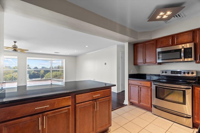 kitchen with ceiling fan, stainless steel appliances, and light tile patterned floors