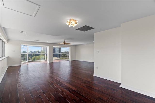 empty room with dark wood-type flooring and ceiling fan