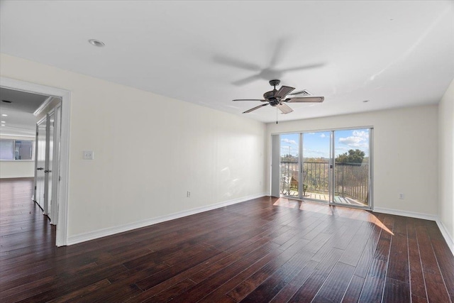 empty room with dark wood-type flooring and ceiling fan