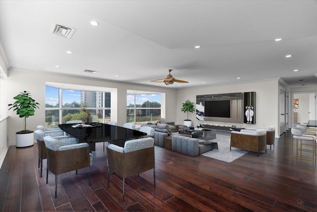 living room featuring crown molding, dark hardwood / wood-style flooring, and ceiling fan