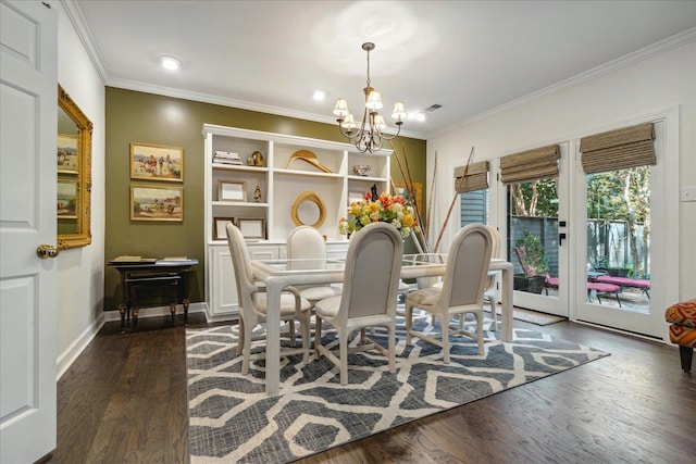 dining area with ornamental molding, dark hardwood / wood-style flooring, and a chandelier