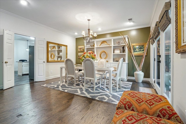 dining room featuring an inviting chandelier, crown molding, and dark hardwood / wood-style flooring