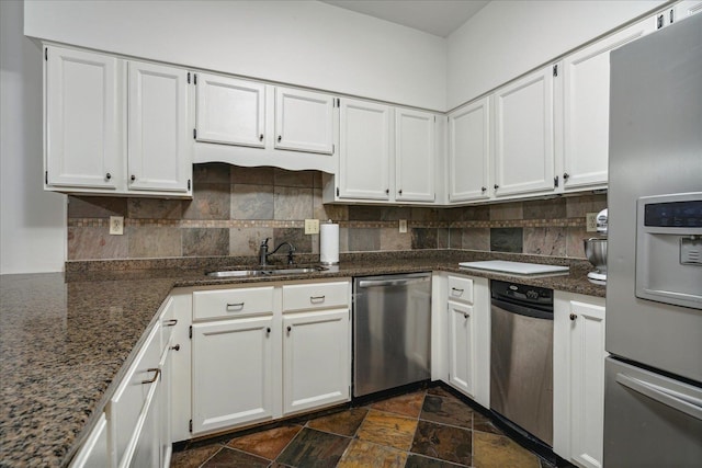 kitchen featuring stainless steel appliances, decorative backsplash, sink, and white cabinets