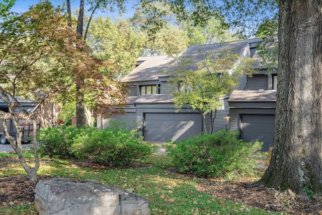 obstructed view of property featuring a garage