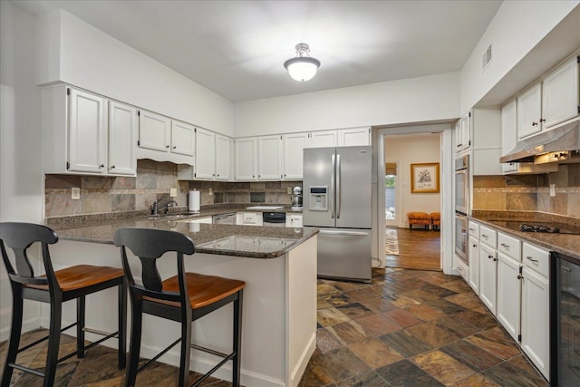 kitchen featuring white cabinetry, kitchen peninsula, and stainless steel appliances