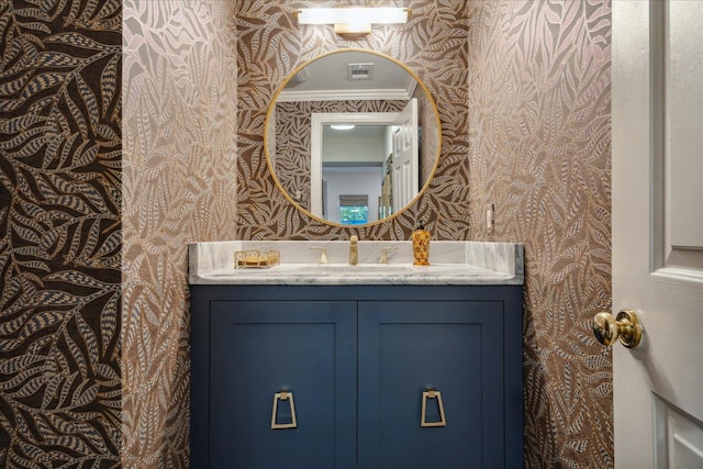 bathroom featuring vanity and ornamental molding