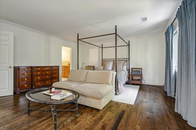 bedroom with ensuite bath, ornamental molding, and dark hardwood / wood-style floors