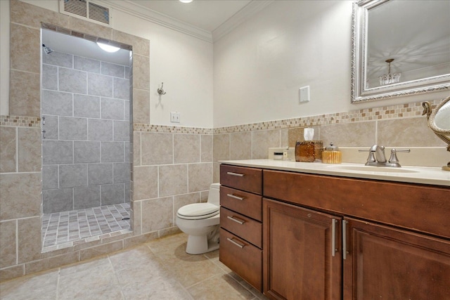 bathroom featuring tile walls, vanity, tiled shower, and toilet