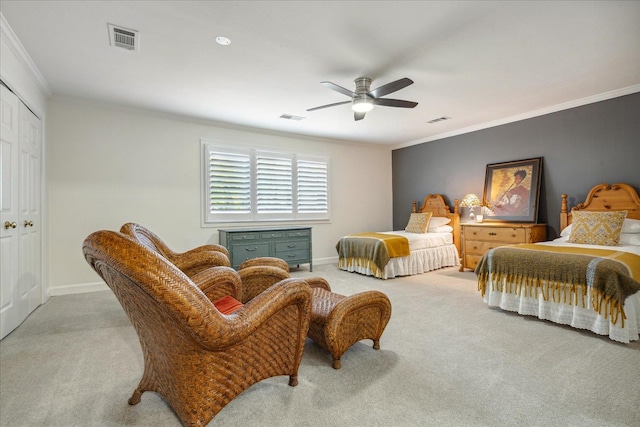 bedroom featuring light carpet, a closet, ornamental molding, and ceiling fan