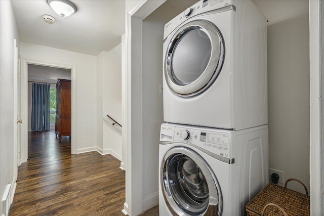 washroom with stacked washer / dryer and dark hardwood / wood-style flooring