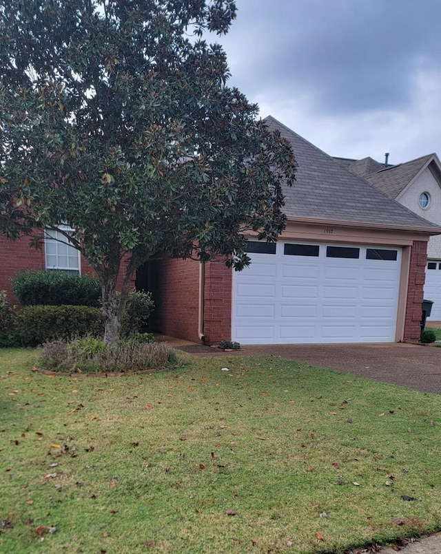 view of side of home featuring a garage and a yard