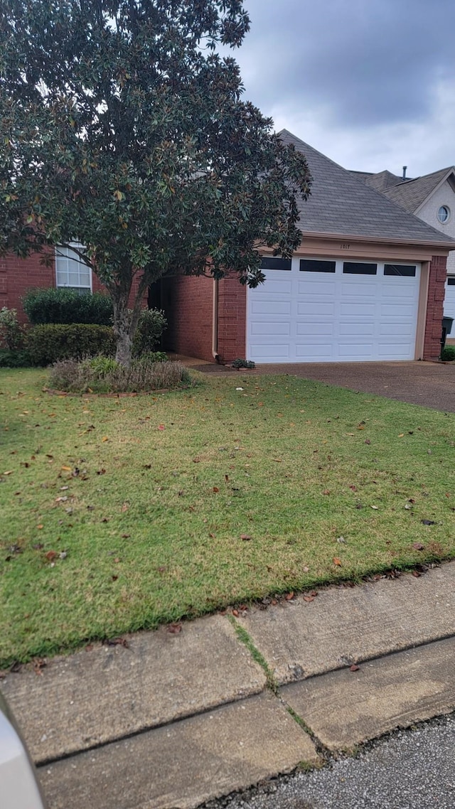 view of side of home with a garage and a yard