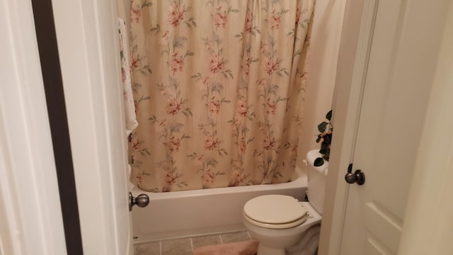 bathroom with shower / tub combo with curtain, toilet, and tile patterned flooring