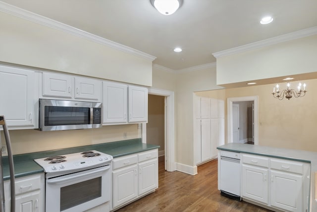 kitchen featuring dark hardwood / wood-style flooring, ornamental molding, white cabinetry, white electric range oven, and a chandelier