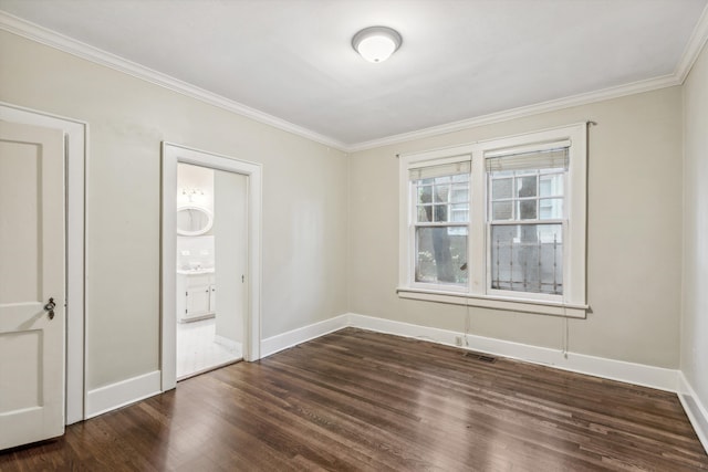 empty room with ornamental molding and dark hardwood / wood-style floors