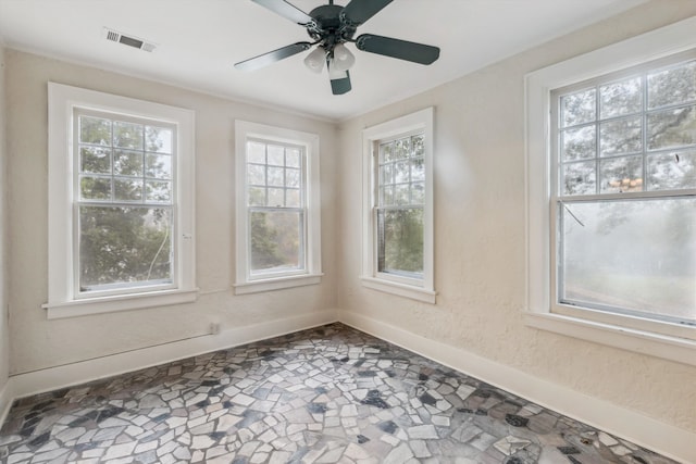 spare room with plenty of natural light and ceiling fan