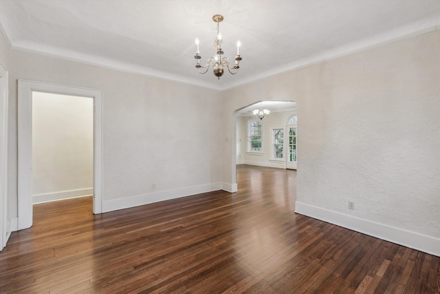 unfurnished room with dark hardwood / wood-style flooring and an inviting chandelier