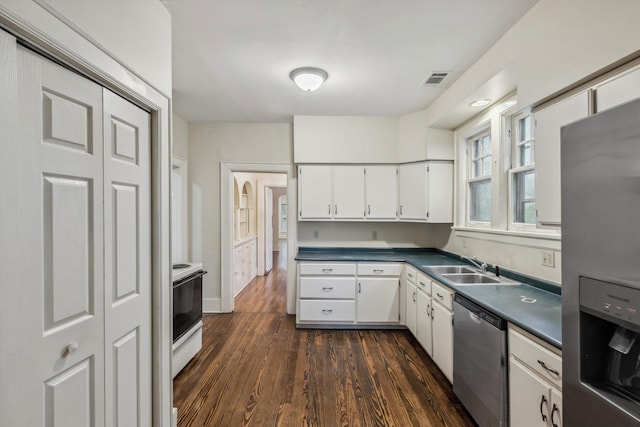 kitchen featuring sink, white cabinetry, stainless steel appliances, and dark hardwood / wood-style floors