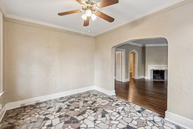 empty room with ornamental molding, hardwood / wood-style flooring, and ceiling fan