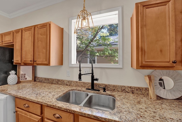kitchen featuring hanging light fixtures, crown molding, light stone counters, and a sink