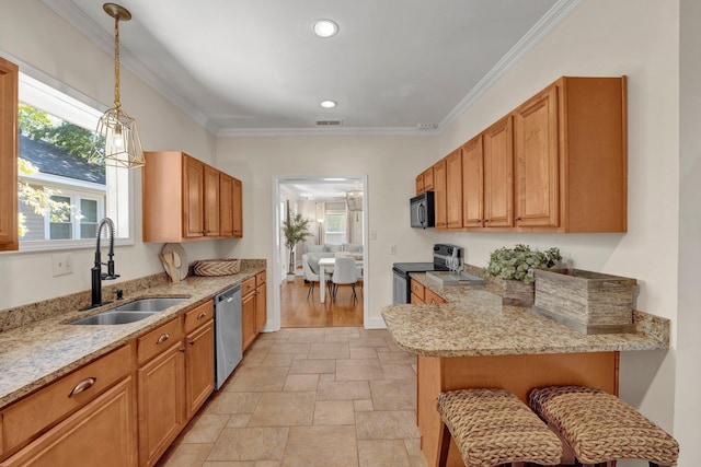kitchen featuring a sink, a peninsula, stone tile flooring, ornamental molding, and appliances with stainless steel finishes