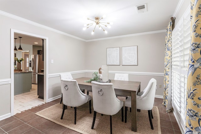 tiled dining area featuring a notable chandelier and ornamental molding