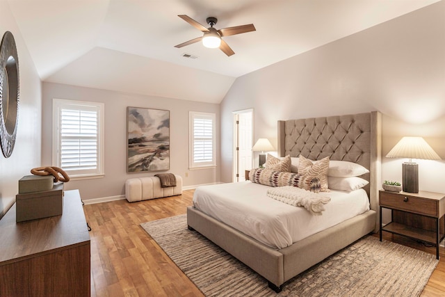 bedroom featuring light hardwood / wood-style floors, lofted ceiling, and ceiling fan