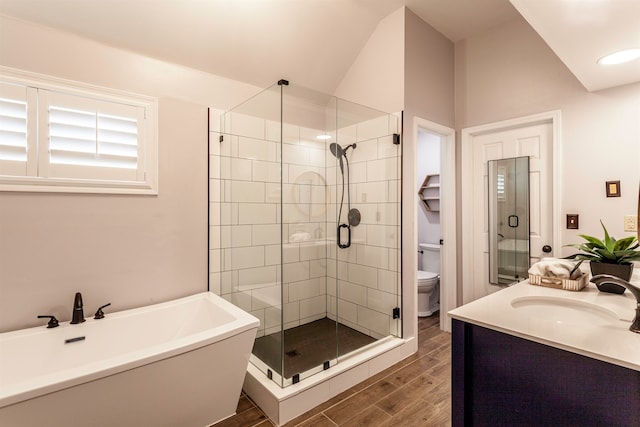 full bathroom featuring vanity, toilet, wood-type flooring, and plus walk in shower