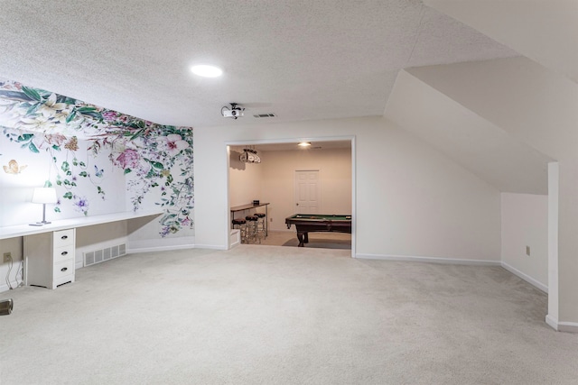 bonus room featuring a textured ceiling, carpet, lofted ceiling, and pool table