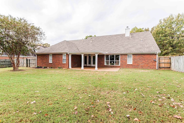 back of property featuring a yard and a patio area