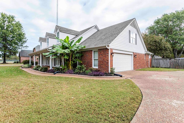 view of front of home featuring a front yard and a garage