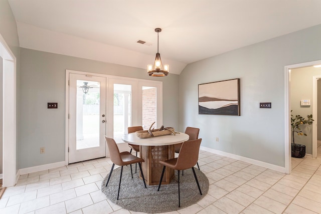 tiled dining area featuring french doors, a notable chandelier, and lofted ceiling