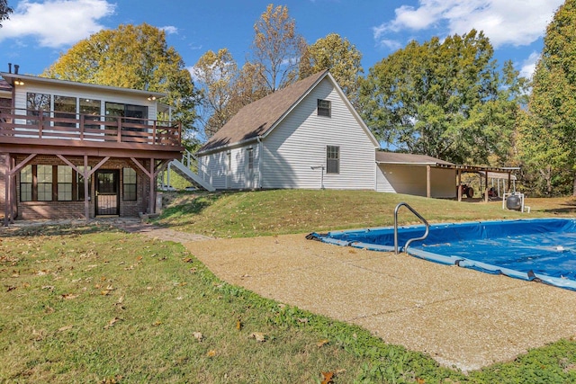 view of swimming pool with a wooden deck and a yard