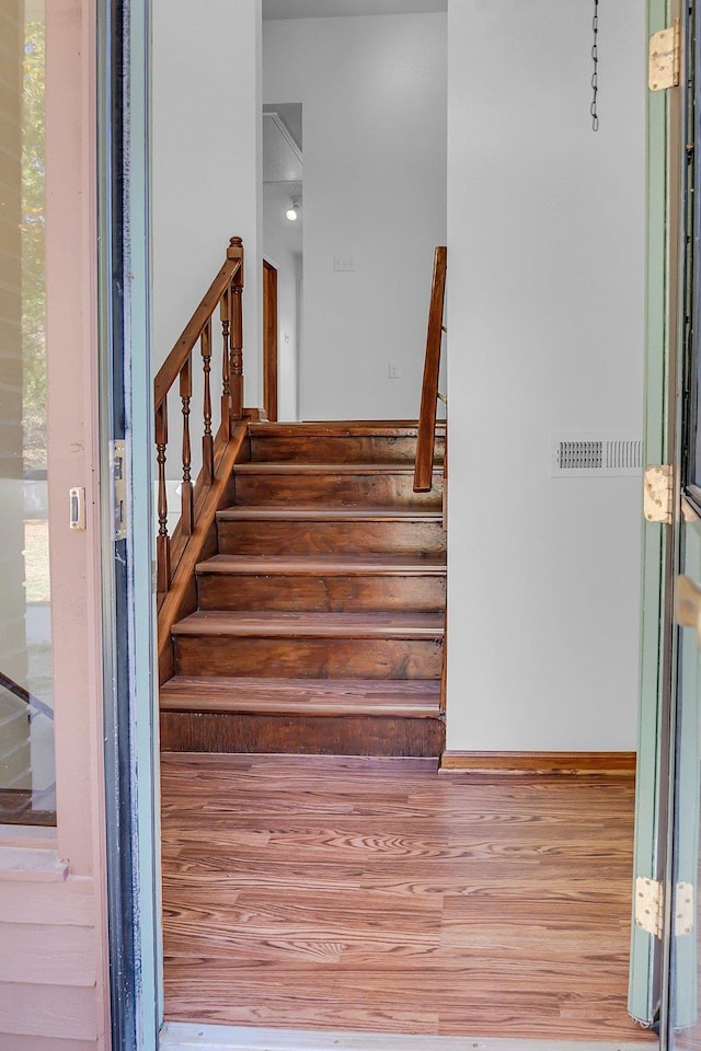 stairs with wood-type flooring