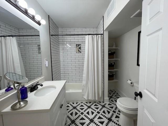 full bathroom with vanity, shower / bathtub combination with curtain, toilet, and tile patterned flooring