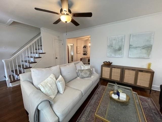 living room with ornamental molding, dark hardwood / wood-style floors, and ceiling fan