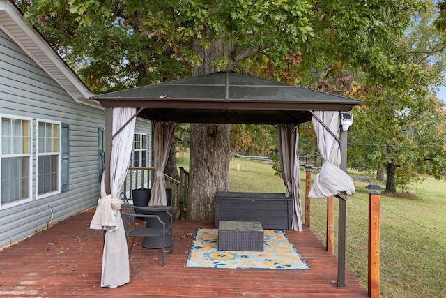 deck featuring a gazebo and a lawn