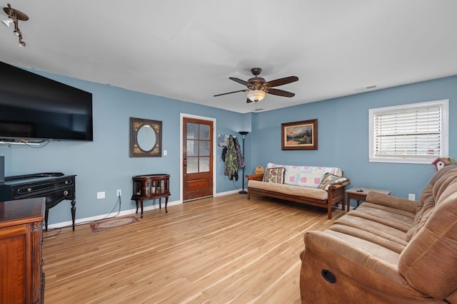 living room featuring ceiling fan and light hardwood / wood-style flooring