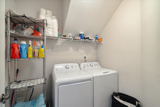 laundry room with a textured ceiling and washing machine and dryer