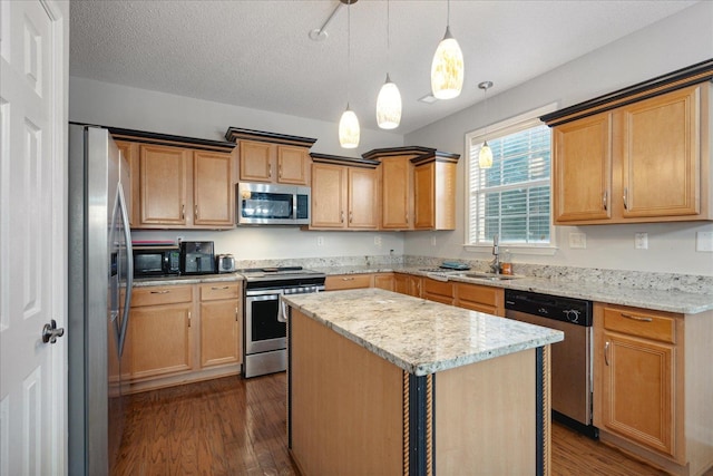 kitchen featuring a kitchen island, a textured ceiling, dark wood-type flooring, decorative light fixtures, and stainless steel appliances