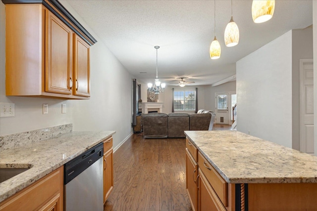 kitchen featuring hanging light fixtures, ceiling fan, stainless steel dishwasher, dark wood-type flooring, and light stone counters