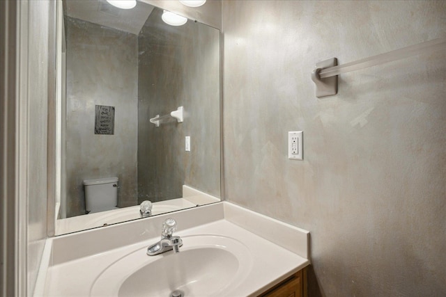 bathroom featuring vanity and toilet