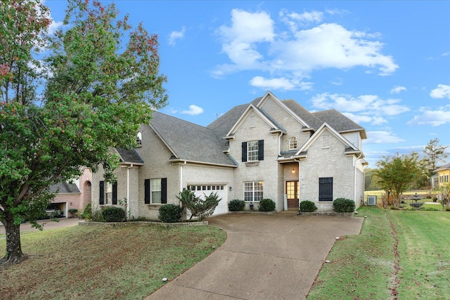 view of front of property with central AC, a garage, and a front lawn