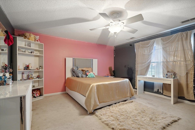 carpeted bedroom with ceiling fan and a textured ceiling