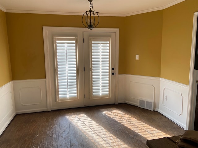 doorway to outside featuring ornamental molding and dark hardwood / wood-style floors