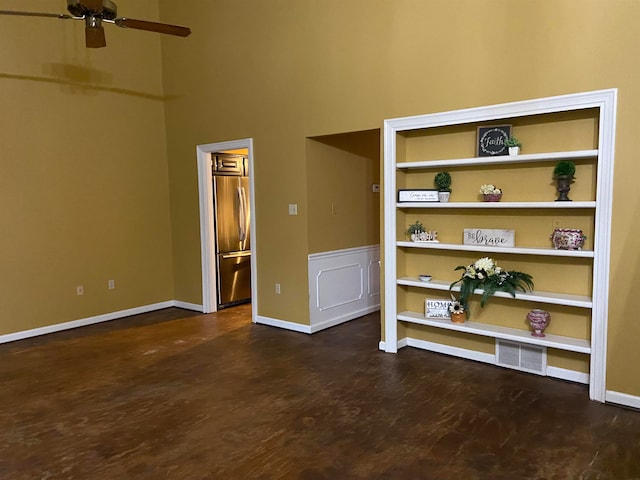 spare room featuring ceiling fan, a towering ceiling, and dark hardwood / wood-style flooring